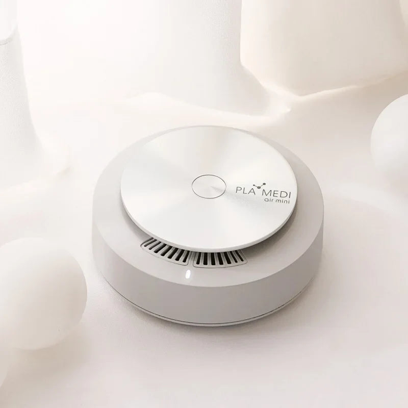 PLABEAU PLAMEDI AIR MINI high-velocity air purifier on a smooth surface, designed for compact space sanitization.