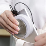 Person holding the compact PLABEAU PLAMEDI AIR MINI high-velocity air purifier, showcasing its portable design.